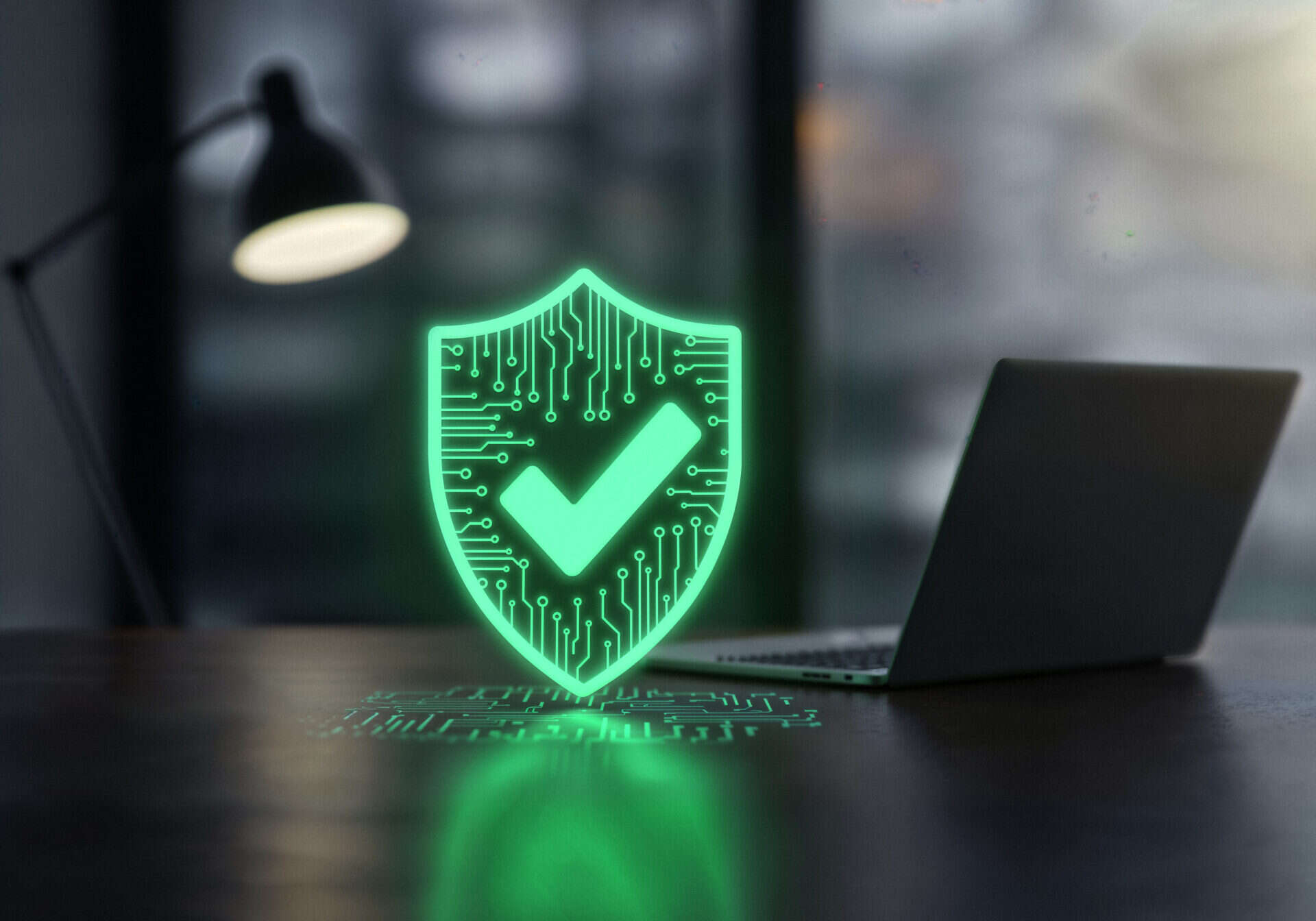 Digital security shield in front of laptop